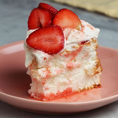 a piece of cake with strawberries on top sits on a pink plate next to a fork