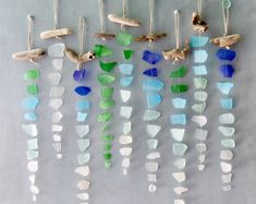 a group of sea glass hanging from hooks