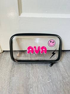 a mirror with the word ava painted on it and a smiley face drawn in pink