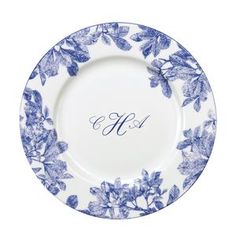 a blue and white floral plate with the letter h on it's center piece