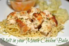 a white plate topped with pasta and meat covered in sauce