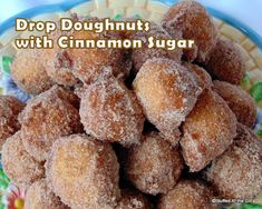 sugar covered doughnuts on a plate with cinnamon sugar in the middle and text overlay that reads, drop doughnuts with cinnamon sugar