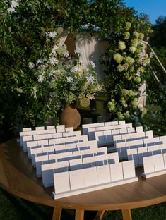 a wooden table topped with lots of white boxes sitting on top of it's sides