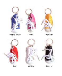 six pairs of tennis shoes keychains in different colors and sizes, all with laces on them