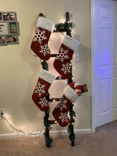 christmas stockings are hung on the wall with lights