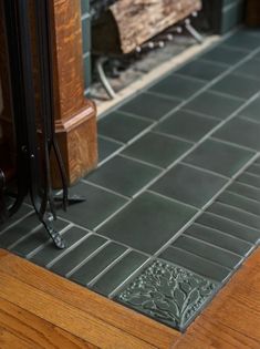 a close up of a tile floor near a fire place