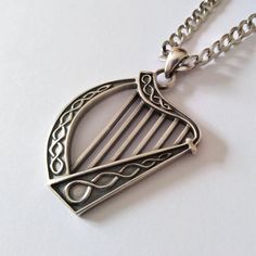 ★ Celtic Lyre/Harp Pendant ★  A beautiful handcrafted Celtic Lyre/Harp pendant/necklace for Men and Women. * Materials/Finishes ➤ Artificially Aged (Black/Grey Oxidized) Silver 925 * Dimensions ➤ ~ 3.7 x 2.8 x 0.3 cm (~ 1.4 x 1.1 x 0.1 inches)/Bail: Suitable for up to ~ 3.0 mm (~ 0.1 inches) Chain * Weight: ~ 10 grams (in Silver 925) ----------------------------------------------------------------------------- IMPORTANT NOTES: --------------------------------------------------------------------- Classic Antique Silver Sterling Silver Necklaces, Classic Antique Silver Sterling Silver Necklace, Handmade Classic Pendant Jewelry, Classic Handmade Pendant Jewelry, Handmade Pendant Necklace For Father's Day, Father's Day Silver Nickel-free Jewelry, Father's Day Nickel Free Silver Jewelry, Unique Oxidized Finish Necklaces, Classic Handmade Silver Necklaces