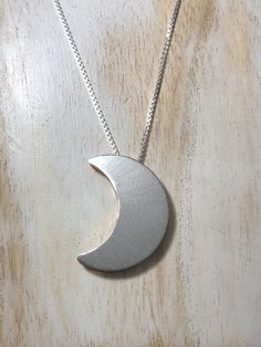 I have made a crescent Moon pendant, inspired by songstress Stevie Nicks! This piece had two sides to which the chain slides through, so you can wear it gold side, or silver side depending on mood and outfit! The entire piece is sterling silver and I 24K gold-plate overlay the other side for a less expensive alternative to solid gold, however, if you want one side to be solid 14K gold, I can do that, too. I've been a fan of Stevie Nicks since I was 6 years old and I began making my version of so Unique Crescent Moon Charm Necklace, Silver Hand Forged Crescent Necklace, Hand Forged Silver Crescent Necklace, Handmade Celestial Half Moon Necklaces, Handmade Celestial Half Moon Necklace, Sterling Silver Half Moon Necklace In Celestial Style, Celestial Half Moon Sterling Silver Necklace, Moon Shaped Necklace With Large Pendant, Sterling Silver Sun And Moon Half Moon Necklace