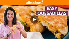 a woman is eating quesadillas in front of the camera and smiling at the camera