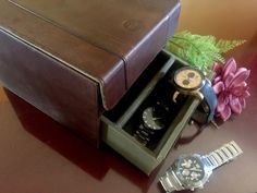 "This dresser top watch case is made of brown genuine leather by Fossil, giving it a sophisticated masculine look with stitched design. It has a top organizer with 6 sectional compartments, each with a cushion to hold the watch. The bottom has a 3-section drawer storage with brass knob to keep other accessories such as cufflinks, tie clips, and jewelry organized. The interior is lined in khaki olive army green canvas fabric. It will be a great wedding gift idea for the groom or groomsmen. Makes Brown Business Watch Accessories With Case Included, Brown Rectangular Watch Accessories For Formal Occasions, Timeless Brown Watch Accessories For Gift, Formal Brown Rectangular Watch Accessories, Classic Brown Watch Accessories For Gift, Brown Automatic Watch Accessories For Business, Formal Brown Leather Watch Accessories, Father's Day Gift Brown Watch Accessories, Classic Formal Watch Accessories With Gift Box