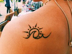 a woman with a sun tattoo on her back