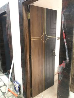 an open door in the middle of a room that is being painted black and gold