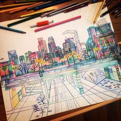 a pencil drawing of a cityscape with trees and buildings in the background, surrounded by crayons