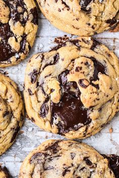 chocolate chip cookies on a baking sheet lined with parchment paper, ready to be eaten