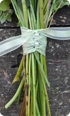 a bunch of green asparagus tied up with a ribbon