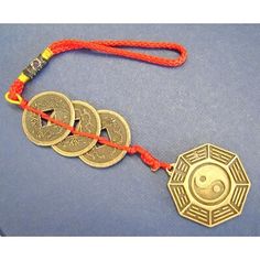 three coins are attached to a string with an orange lanyard around them on a blue surface