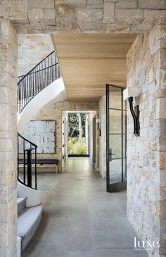 an entry way with stone walls and stairs