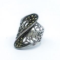 We're in love with this beautiful sterling silver and marcasite ring. Lovely filigree detail makes this ring incredibly organic and intricate and the curve lined with marcasite gives it a modern geometric feel. Has "925" mark on inner band. This item is second-hand and vintage and therefore may show signs of wear and age including but not limited to: scratches, tarnish, faded marks. Ring is Size 7. All items are sold "As Is" and all sales are final. Most pieces are one of a kind and can not be replaced. We will give you as much information as possible regarding the pieces condition including supplying additional pictures if needed. Due to the nature of antique and vintage items there may be blemishes, nicks or other imperfections as expected with age and use. If you want more information a Elegant Silver Marcasite Rings, Marcasite Ring, Sterling Silver Filigree, Silver Filigree, Vintage Sterling Silver, Rings Statement, Statement Rings, Vintage Items, Im Not Perfect