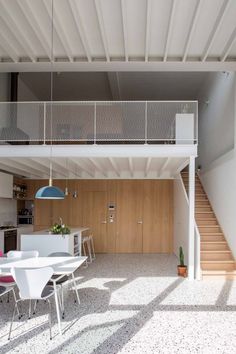 an open floor plan with white chairs and tables