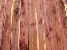 a close up of a wooden fence with nails on the top and bottom part of it