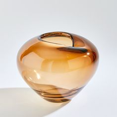 The Undulating Vase is true to its name with a smooth rising and falling shape. Each piece is a unique hand-blown art glass from Polish artisans. Dimensions Overall 10"H x 12"Dia. (22.6 lbs)  Finish Dark Amber Hand Wash or damp cloth Product is Watertight Amber Vase, Lounge Interiors, Global Views, Hand Blown, Art Glass, Glass Art, Amber, Hand Wash, Lounge