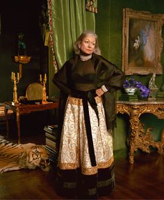 an older woman standing in a green room