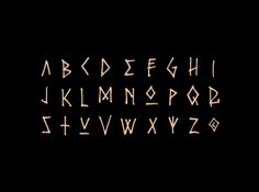 an old fashioned font that has been drawn in gold ink on a black background with the letters