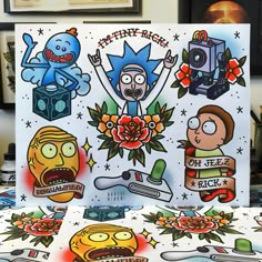 an assortment of cartoon stickers on a table in front of some pictures and paintings