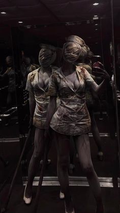 two mannequins dressed as zombies in a store window