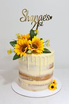 a white cake with sunflowers on top