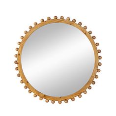 a round mirror with beaded trim around the edges and an oval wooden frame, on a white background