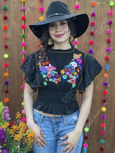 This beautiful Flounce Sleeve Top is the perfect Top for a fun day out or special event. The adorable fluttery sleeves and colorful hand embroidered flowers make it flirty and fun. It's made out of fine Mexican cotton, has an elastic waist and has colorful flowers embroidered completely by hand. This blouse is made with love by Mexican Artisans in Chiapas, Mexico. Please note: This blouse comes in one size which fits sizes Small and Medium. Purchase the Mexican hats here: https://www.etsy.com/es Fitted Black Embroidered Top For Festival, Fitted Floral Embroidered Top For Festival, Fitted Multicolor Embroidered Top For Festival, Black Summer Festive Blouse, Black Festive Blouse For Summer, Festive Black Blouse For Summer, Spring Traditional Embroidered Fitted Top, Fitted Traditional Embroidered Top For Spring, Embroidered Fitted Festival Blouse