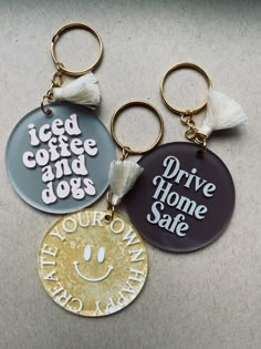 three key chains with different designs on them