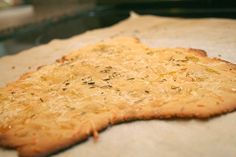 an uncooked pizza sitting on top of a piece of paper