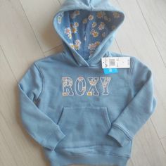 Roxy Hope You Believe Collection Blue Floral Hoodie Pullover Embroidered Roxy On Front Front Pouch Pocket Ribbed Hem New Retail $46 Sz 4 Girls Smoke & Pet Free Home Beach Swim Party Surfing Easter Summer Spring Vacation Sun Roxy Quiksilver Ripcurl O'neill Hurley Matilda Jane Billabong Tea Collection Kate Spade Juicy Couture Persnickety Matilda Jane Fresh Frocks Sweet Gap Honey Mudpie Mustard Pie Janieandjack Jelly The Pug Gigglemoon Rylee+Cru Anthropologie Zara Swankybabyvintage Holiday Birthday Playful Blue Hoodie With Long Sleeves, Playful Blue Long Sleeve Hoodie, Blue Long Sleeve Playful Hoodie, Cute Blue Tops With Drawstring Hood, Playful Blue Hoodie Top, Playful Blue Winter Sweatshirt, Cute Blue Hoodie Top, Cute Blue Hooded Hoodie, Cute Blue Fleece Hoodie