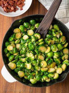 brussel sprouts in a skillet with bacon on the side