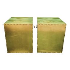 a pair of green leather stools with riveted edges