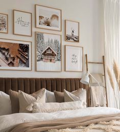 a bedroom with pictures on the wall above the bed