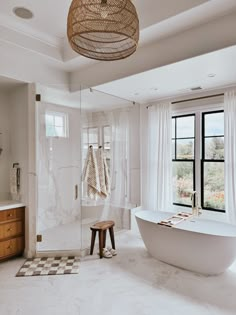 a bathroom with a large tub and checkered rugs on the floor next to it