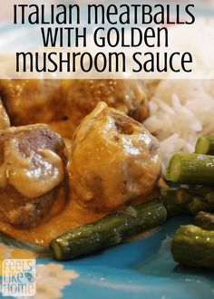 meatballs and gravy on a plate with rice, asparagus and green beans