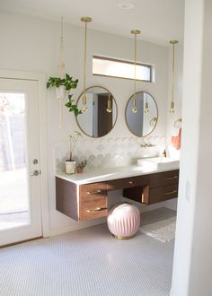 a bathroom with two sinks and mirrors on the wall