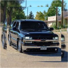 a black truck parked in front of a house