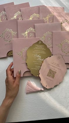 pink and gold wedding stationery with tasseled envelopes, cards and matching guest book