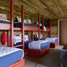 a room with bunk beds, couches and american flags on the wall in it