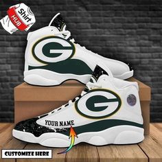 the green bay packers sneakers are on display in front of a brick wall and wooden floor