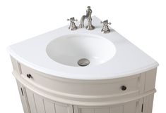 a white sink with two faucets on the side and a cabinet underneath it