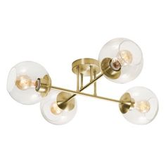 three light brass ceiling fixture with glass globes and four lights on each end,