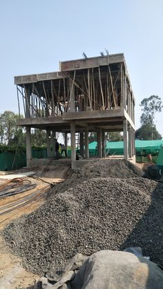 a large pile of dirt next to a building under construction