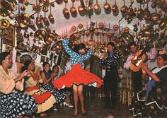 a group of people standing in front of a room filled with pots and pans