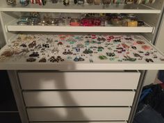 a white cabinet filled with lots of jewelry